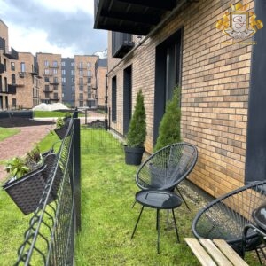 Insulated facade and courtyard with lawn and decorative elements